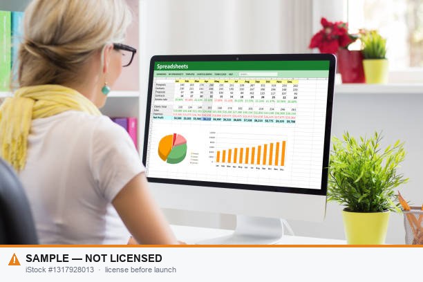Billing specialist reviewing collections, charts, and claims data on a computer — the reporting visibility MMSM brings Michigan providers